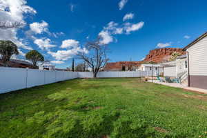 Fenced backyard with a patio