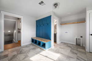 Mudroom, laundry and half bath, basement entrance