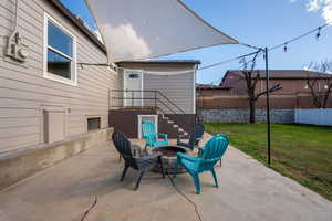 View of patio with a fire pit