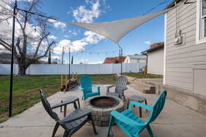 Fenced backyard with a patio area and an outdoor fire pit