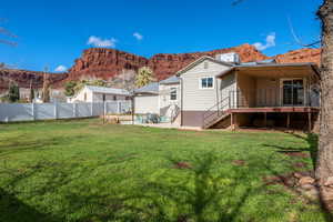 Back of property featuring a mountain view, a patio, and a fenced backyard