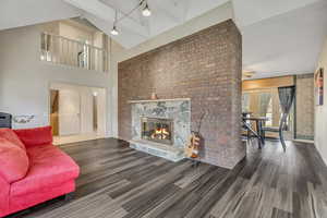 Living Room with Fireplace and Balcony above