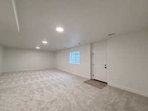 Below grade area featuring light carpet and recessed lighting