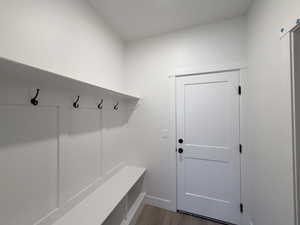 Mudroom with light wood finished floors and baseboards