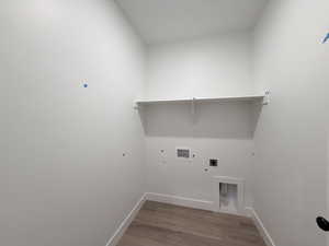 Laundry room with hookup for an electric dryer, light wood-style flooring, and hookup for a washing machine