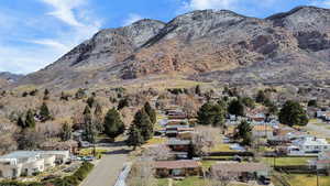 View of mountain backdrop featuring nearby suburban area