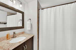 Full bath featuring vanity and a shower with curtain
