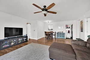 Living room featuring wood finished floors and a ceiling fan