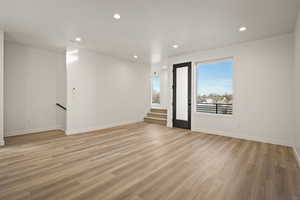 Empty room with recessed lighting and light wood-style floors