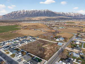 Aerial view of property's location featuring nearby suburban area and rural landscape