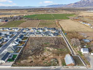 View of property location featuring mountains, rural landscape, and nearby suburban area