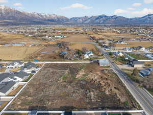 Aerial overview of property's location featuring nearby suburban area and a mountainous background