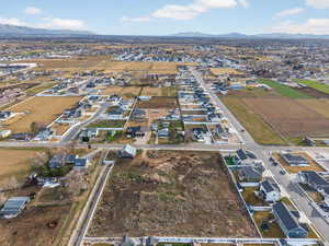 Aerial view of property's location featuring nearby suburban area and a mountain backdrop