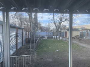 Fenced backyard with an outbuilding