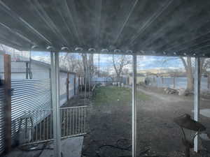 Fenced backyard with an outdoor structure and a water view