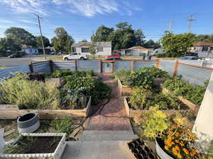 View of yard with a vegetable garden and a residential view