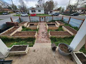 View of yard featuring a residential view and a vegetable garden