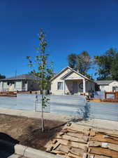 Bungalow with covered porch, a residential view, and a fenced front yard