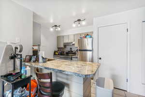 Kitchen with a breakfast bar area and laundry in closet