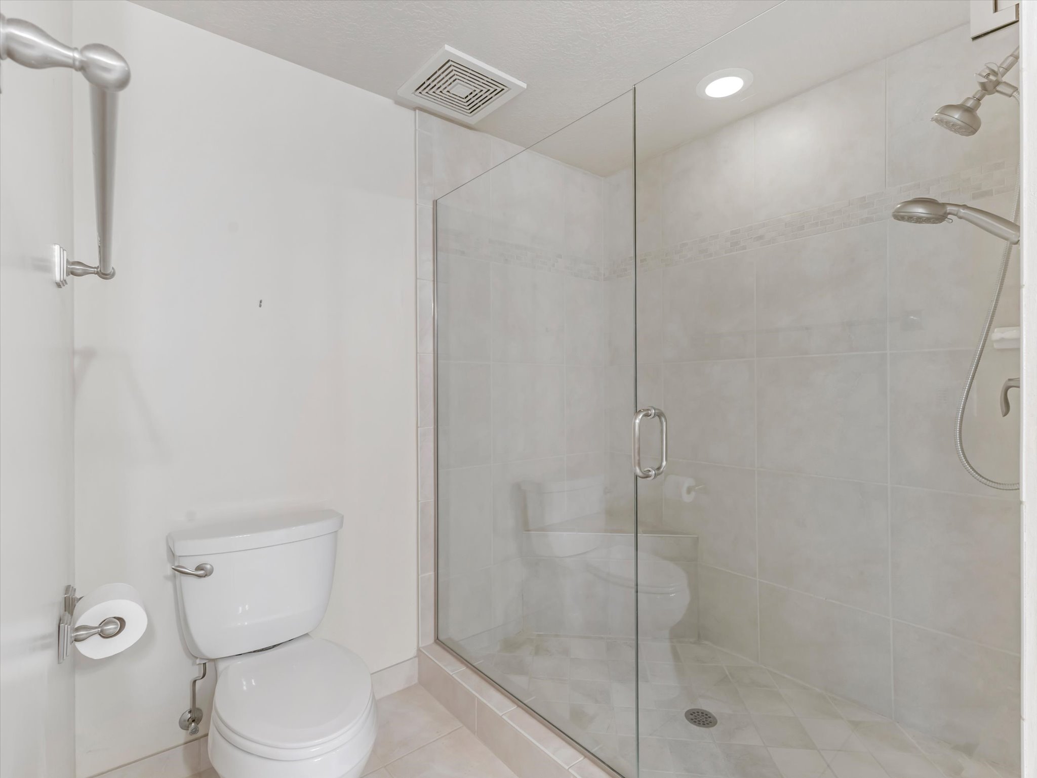 Bathroom featuring a stall shower, tile patterned floors, and recessed lighting