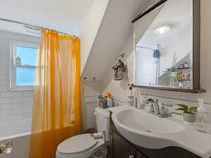 Bathroom with vanity and shower / tub combo with curtain