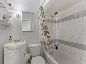 Bathroom with vanity and shower / tub combo with curtain