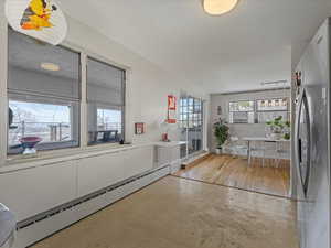 Interior space featuring baseboard heating and concrete floors