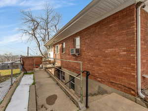 View of home's exterior featuring brick siding and a gate