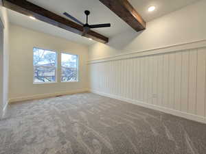 Empty room with ceiling fan, carpet flooring, a wainscoted wall, beamed ceiling, and recessed lighting