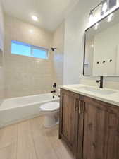 Full bath with vanity, shower / washtub combination, and light wood finished floors