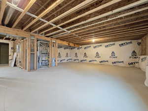 Unfinished below grade area featuring water heater