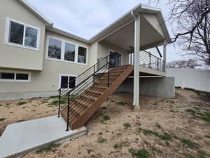 Doorway to property with stucco siding and a patio