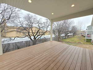 Wooden deck featuring a lawn