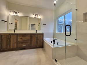 Full bath with a garden tub, double vanity, and a shower stall