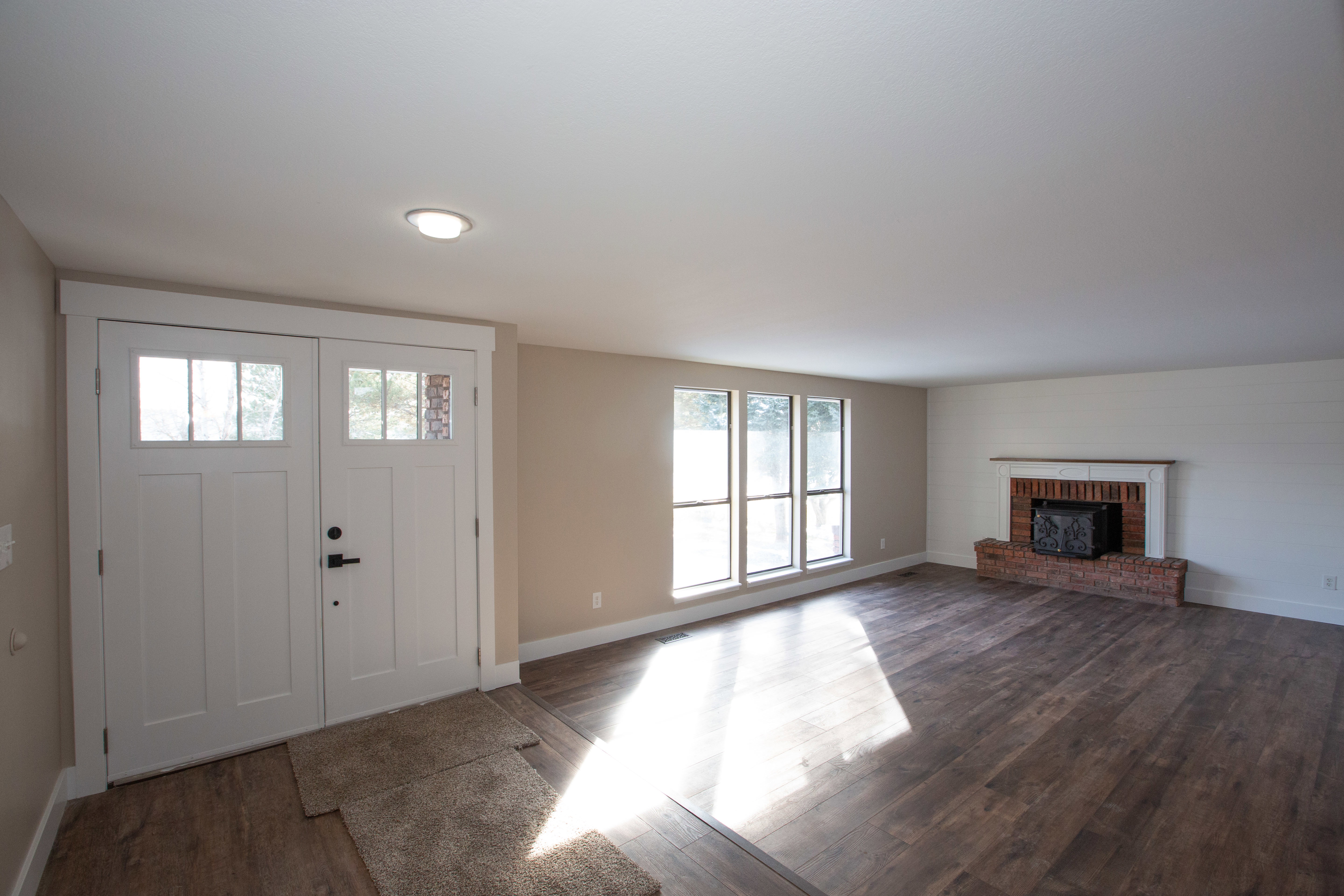Entrance foyer featuring dark LVP flooring and a fireplace