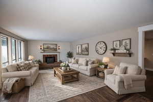 Virtually Staged Living area featuring wood finished floors and a brick fireplace
