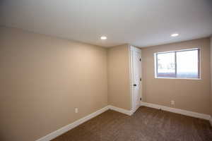 Bedroom 4 with recessed lighting and dark carpet
