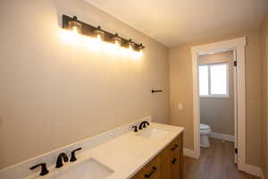 Updated full master bathroom featuring double vanity and LVP floors