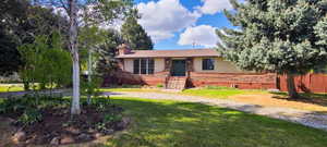 Brick and siding exterior featuring a green entry door