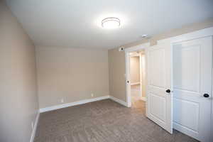 Bedroom 6 with baseboards and carpet floors