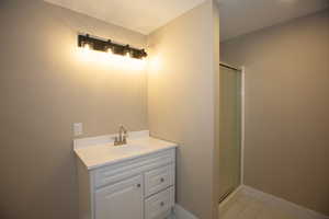 Updated bathroom with vanity and a shower stall