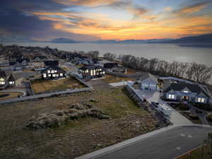 Aerial view at dusk of a residential view and a water and mountain view