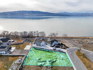 Aerial overview of property's location featuring property boundaries highlighted and a water and mountain view