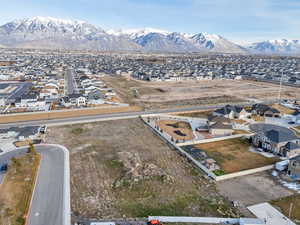 Aerial view of property's location with nearby suburban area and a mountain backdrop