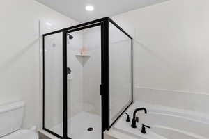 Bathroom with a stall shower and a garden tub