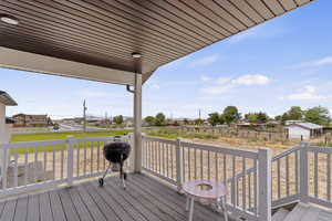 Wooden terrace with a residential view and a grill