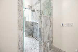 Bathroom with a marble finish shower