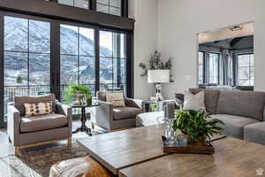 Living room with a mountain view, a high ceiling, and wood finished floors