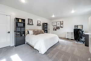 Bedroom featuring light colored carpet, an office area, and recessed lighting