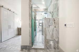 Bathroom featuring a marble finish shower and marble finish flooring